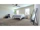 Bright, spacious bedroom with two windows, and a large mirror providing ample light and style at 18809 W Wilson St, Buckeye, AZ 85326