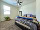Spacious bedroom with a large window and comfortable bed with storage bench at 18809 W Wilson St, Buckeye, AZ 85326