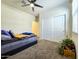 Comfortable bedroom featuring a ceiling fan, closet, and a window letting in plenty of natural light at 18809 W Wilson St, Buckeye, AZ 85326