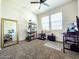 Bedroom featuring decorative mirror, shelving, ceiling fan and desk at 18809 W Wilson St, Buckeye, AZ 85326