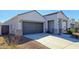 Charming single-Gathering home featuring a two-car garage and covered entrance with desert landscaping at 18809 W Wilson St, Buckeye, AZ 85326