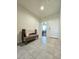 Hallway with tiled floors, accent bench, and bedroom views at 18809 W Wilson St, Buckeye, AZ 85326