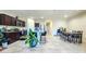 Open-concept kitchen with dark cabinets, granite countertops, stainless steel appliances and adjacent dining area at 18809 W Wilson St, Buckeye, AZ 85326