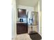 Kitchen featuring stainless steel refrigerator and dark cabinets, offering ample storage and style at 18809 W Wilson St, Buckeye, AZ 85326