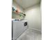Functional laundry room with modern washer and dryer, plus convenient shelving for storage at 18809 W Wilson St, Buckeye, AZ 85326