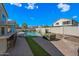 Spacious backyard with a sparkling pool, patio area, and lush green lawn at 1928 E 39Th Ave, Apache Junction, AZ 85119