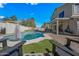 Relaxing backyard features a pool, patio with comfortable chairs, and mature trees at 1928 E 39Th Ave, Apache Junction, AZ 85119