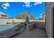 This backyard has a pool, built-in grill, a covered patio, turf, and lounge seating at 1928 E 39Th Ave, Apache Junction, AZ 85119