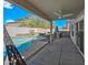 This backyard features a pool, a covered patio with a fan, a built-in grill, and turf at 1928 E 39Th Ave, Apache Junction, AZ 85119