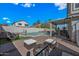 Inviting backyard with a pool, patio seating, and a charming fire pit area at 1928 E 39Th Ave, Apache Junction, AZ 85119