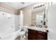 Bright bathroom featuring a granite vanity countertop, a tub with white tiles, and modern fixtures at 1928 E 39Th Ave, Apache Junction, AZ 85119