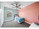 Bedroom featuring a bright pink accent wall, ceiling fan and lots of natural light at 1928 E 39Th Ave, Apache Junction, AZ 85119
