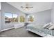 Bright bedroom with vaulted ceilings, soft carpet, and generous windows showcasing neighborhood views at 1928 E 39Th Ave, Apache Junction, AZ 85119