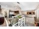 Open concept dining room view features a sleek chandelier and seamlessly connects to the kitchen and living spaces at 1928 E 39Th Ave, Apache Junction, AZ 85119