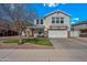 Charming two-story home featuring stone accents, a well-manicured lawn, and a welcoming front porch at 1928 E 39Th Ave, Apache Junction, AZ 85119