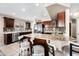 This eat-in kitchen features sleek dark cabinets, stainless steel appliances and an island with a granite countertop at 1928 E 39Th Ave, Apache Junction, AZ 85119