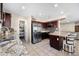 The kitchen features granite countertops, tiled floors, stainless steel appliances, and dark wood cabinets at 1928 E 39Th Ave, Apache Junction, AZ 85119