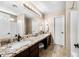 Bright main bathroom with granite counters, double sinks, and a shower/tub combination at 1928 E 39Th Ave, Apache Junction, AZ 85119