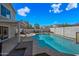 Backyard with a sparkling pool, covered patio, and privacy fencing at 1928 E 39Th Ave, Apache Junction, AZ 85119