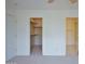 Carpeted bedroom with walk-in closet and attached bathroom at 19348 W Brave Rd, Buckeye, AZ 85326