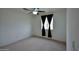 Comfortable bedroom with a ceiling fan and a bright window with privacy curtains at 19348 W Brave Rd, Buckeye, AZ 85326