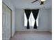 Comfortable bedroom featuring a closet and a window with decorative curtains at 19348 W Brave Rd, Buckeye, AZ 85326
