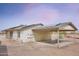 Image displaying the property's carport, solar panels, and neutral exterior paint under a vibrant sky at 19348 W Brave Rd, Buckeye, AZ 85326