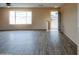 Inviting living room with stylish laminate flooring and plenty of natural light at 19348 W Brave Rd, Buckeye, AZ 85326