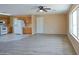 Spacious living room with wood-style flooring and a ceiling fan at 19348 W Brave Rd, Buckeye, AZ 85326