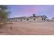 Rear view of the home with a fenced yard at 19348 W Brave Rd, Buckeye, AZ 85326