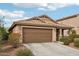 Inviting home showcasing desert landscaping, a two-car garage, and a covered entryway with stone accents at 2014 E Anderson Dr, Phoenix, AZ 85022