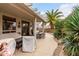 Inviting covered patio with outdoor dining set and lush landscaping at 20319 N Painted Sky Dr, Surprise, AZ 85374