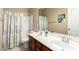 Well-lit bathroom with a tub and shower combo, and a double sink vanity at 20905 N Danielle Ave, Maricopa, AZ 85138
