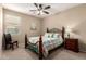 Charming bedroom featuring a bed with an ornate headboard and a ceiling fan at 20905 N Danielle Ave, Maricopa, AZ 85138