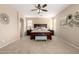 Bright bedroom features a ceiling fan, carpeted floors, and a comfortable, inviting bed at 20905 N Danielle Ave, Maricopa, AZ 85138