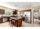 Contemporary kitchen showcasing stainless steel appliances, a central island with seating, and wood-finished cabinetry at 20905 N Danielle Ave, Maricopa, AZ 85138