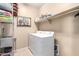 Laundry room featuring a washer, a dryer, shelving, and a wire rack for storing items at 20905 N Danielle Ave, Maricopa, AZ 85138