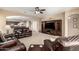 Open-concept living room with comfortable seating, a large TV, and seamless flow to the kitchen and dining areas at 20905 N Danielle Ave, Maricopa, AZ 85138