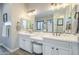 Bright bathroom with a double sink vanity, a large mirror and warm, modern fixtures at 2113 N Trowbridge St, Mesa, AZ 85207