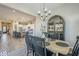 View of open concept kitchen and living room through dining room with chandelier and decorative hutch at 2113 N Trowbridge St, Mesa, AZ 85207