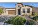 Charming single-Gathering home features a stone facade, manicured lawn, and a two-car garage, creating a welcoming curb appeal at 2113 N Trowbridge St, Mesa, AZ 85207