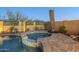 Backyard featuring a pristine pool, spa, and a meticulously designed patio with ample space for outdoor gatherings at 2113 N Trowbridge St, Mesa, AZ 85207