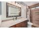 Bathroom vanity with tile surround and natural light from window in shower at 2327 W Rockwell Ct, Chandler, AZ 85224