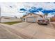 Single-story home with a spacious driveway, two-car garage, and lawn area at 2327 W Rockwell Ct, Chandler, AZ 85224
