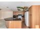Eat-in kitchen featuring wood cabinets, black counters, and a decorative ceiling at 2327 W Rockwell Ct, Chandler, AZ 85224
