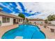 Backyard pool with diving board, fence and covered patio at 2327 W Rockwell Ct, Chandler, AZ 85224