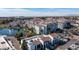 Elevated aerial view of white buildings with tile roofs, adjacent to a serene pond with a fountain at 2511 W Queen Creek Rd # 479, Chandler, AZ 85248