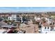 Aerial view of white buildings with tile roofs, lush landscaping, and a roundabout with palm trees at 2511 W Queen Creek Rd # 479, Chandler, AZ 85248