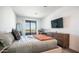 A well-lit bedroom with a large window, desk, and dresser offers style and functionality at 2511 W Queen Creek Rd # 479, Chandler, AZ 85248
