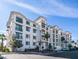 Attractive four-story condo building with a white exterior and a neatly kept surrounding landscape at 2511 W Queen Creek Rd # 479, Chandler, AZ 85248